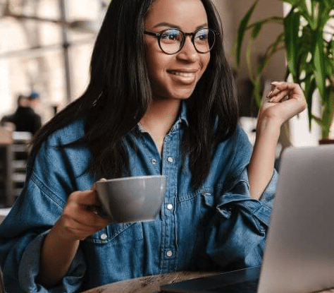 woman with coffee in hand smiling while in online therapy | Online Eating Disorder Treatment in Los Angeles | San Francisco, CA 94115 and San Carlos, CA 94070